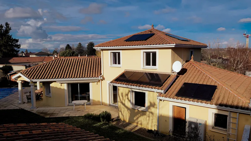Maison à étage, panneaux noirs sur le toit en tuiles